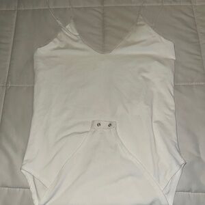White strapped body suit, buttons on the bottom